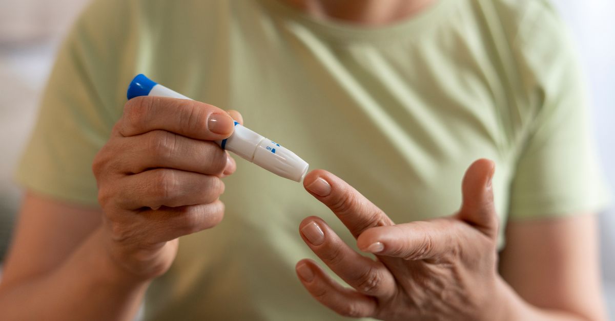 image of an elderly woman pricking her finger for in-home blood test to check sugar level