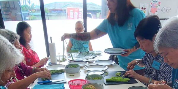 The elderly preparing nasi ulam for lunch together at the daycare