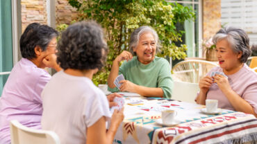 Illustration of a group of elderly women playing cards together