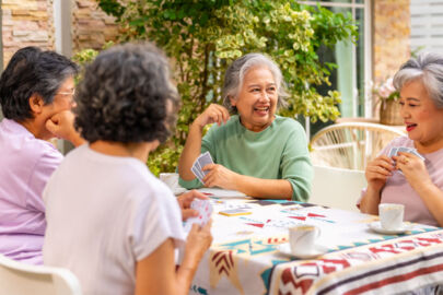 Illustration of a group of elderly women playing cards together