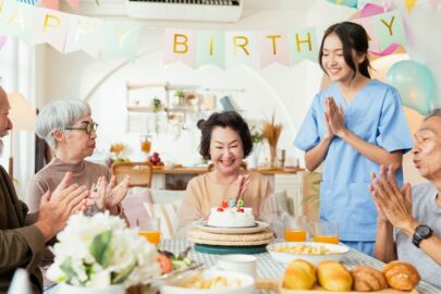 Image of a group of elderly celebrating a birthday together at the senior daycare